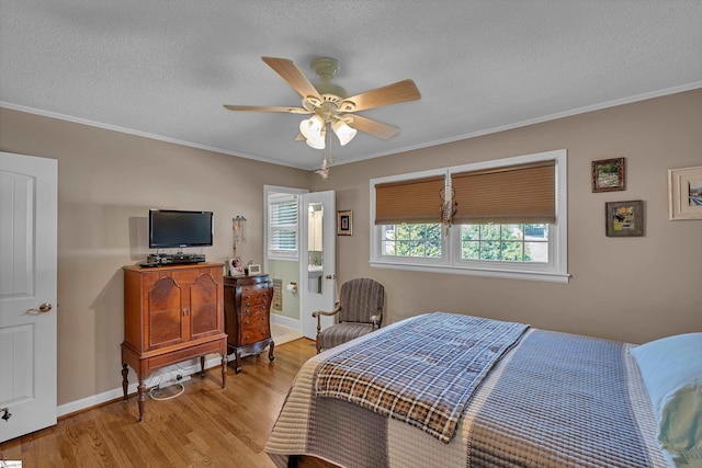 135 James Ave, Wellford, SC 29385 - bedroom with light wood finished floors, a textured ceiling, ornamental molding, and ceiling fan
