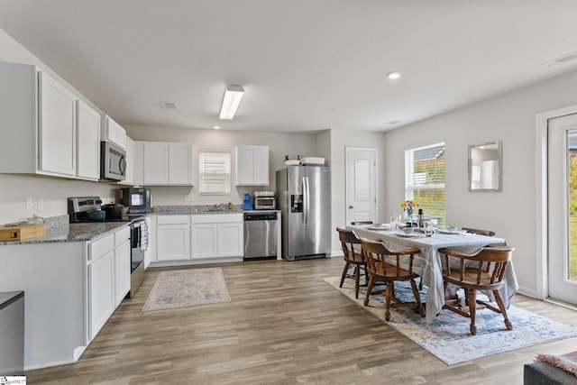 314 Long Grove Ln, Greer, SC 29650 - kitchen featuring appliances with stainless steel finishes, light wood finished floors, white cabinets, light stone counters, and recessed lighting