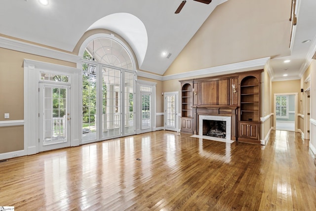 15 Annas Pl, Simpsonville, SC 29681 - unfurnished living room with a ceiling fan, a high end fireplace, high vaulted ceiling, wood finished floors, and healthy amount of natural light