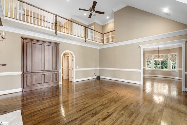 15 Annas Pl, Simpsonville, SC 29681 - unfurnished living room with high vaulted ceiling, a ceiling fan, a chandelier, arched walkways, and wood finished floors
