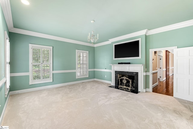 15 Annas Pl, Simpsonville, SC 29681 - unfurnished living room with carpet floors, ornamental molding, a chandelier, and a fireplace