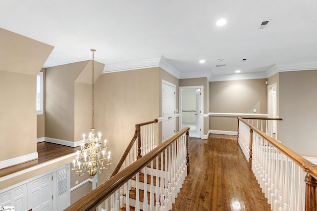 15 Annas Pl, Simpsonville, SC 29681 - hall featuring an upstairs landing, a chandelier, recessed lighting, wood finished floors, and crown molding