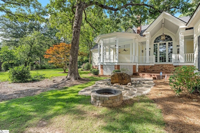 15 Annas Pl, Simpsonville, SC 29681 - view of green lawn featuring an outdoor fire pit, ceiling fan, and covered porch