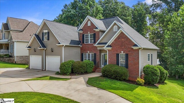 118 Glencreek Dr, Greer, SC 29650 - view of front facade with driveway, brick siding, a front yard, and a shingled roof