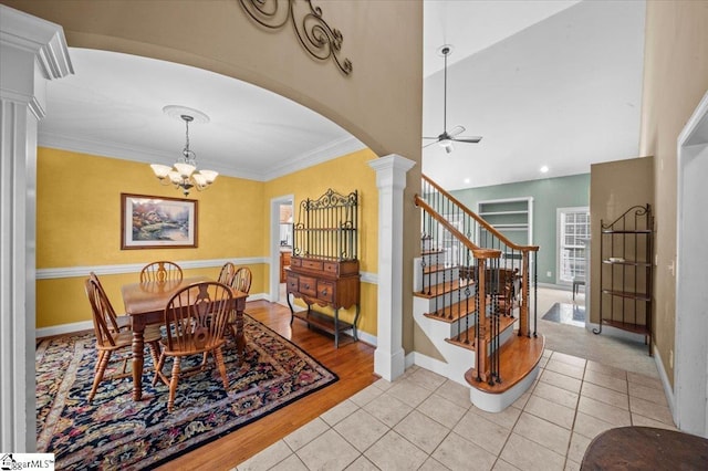118 Glencreek Dr, Greer, SC 29650 - dining space with a chandelier, a ceiling fan, ornate columns, arched walkways, and light tile patterned flooring