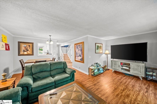 2 Creekside Way, Greenville, SC 29609 - living room with a chandelier, a textured ceiling, wood finished floors, crown molding, and stairs