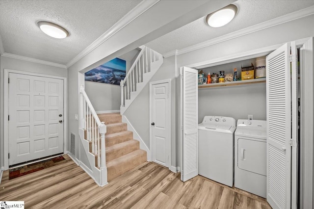 2 Creekside Way, Greenville, SC 29609 - laundry room with a textured ceiling, separate washer and dryer, light wood-style flooring, and crown molding