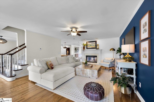 109 W Fieldsparrow Cir, Greenville, SC 29615 - living room featuring wood finished floors, a brick fireplace, a ceiling fan, ornamental molding, and stairway
