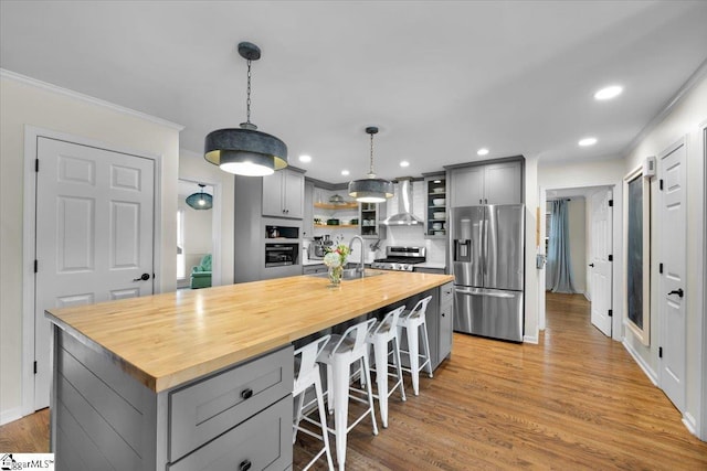 109 W Fieldsparrow Cir, Greenville, SC 29615 - kitchen with appliances with stainless steel finishes, gray cabinets, butcher block counters, wall chimney exhaust hood, and crown molding