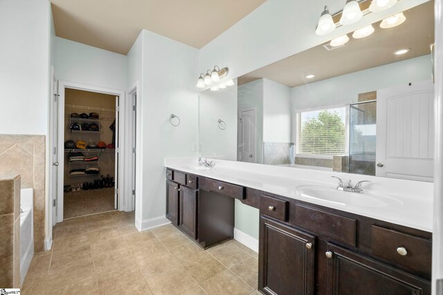 415 Bridge Crossing Dr, Simpsonville, SC 29681 - full bathroom featuring a shower stall, a spacious closet, double vanity, a bath, and tile patterned floors