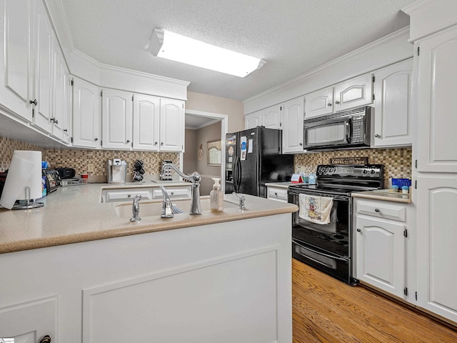 209 Thornhill Dr, Spartanburg, SC 29301 - kitchen with black appliances, white cabinets, and tasteful backsplash