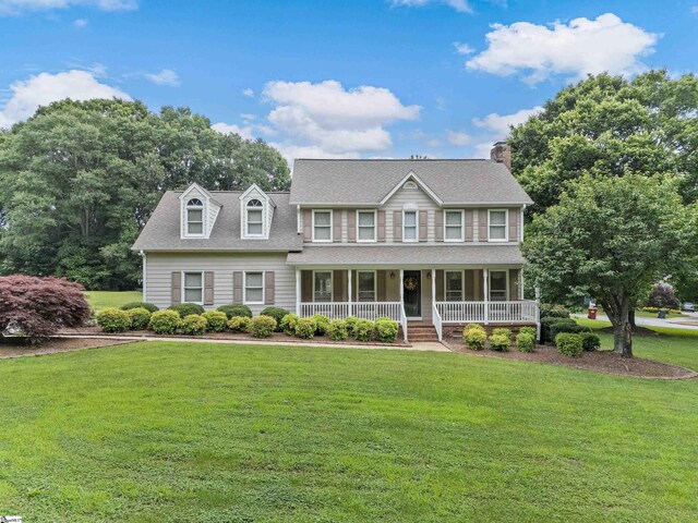 209 Thornhill Dr, Spartanburg, SC 29301 - colonial-style house with covered porch, a front lawn, and a chimney