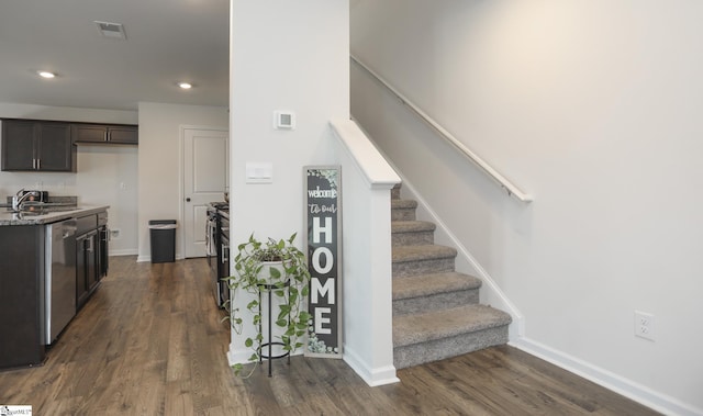 1421 Trotting Ave, Roebuck, SC 29376 - kitchen with appliances with stainless steel finishes, dark wood finished floors, recessed lighting, dark brown cabinets, and light stone countertops