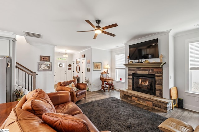 27 Mossycup Rd, Taylors, SC 29687 - living room with crown molding, ceiling fan, a stone fireplace, stairs, and wood finished floors