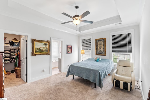 27 Mossycup Rd, Taylors, SC 29687 - carpeted bedroom featuring a tray ceiling, a spacious closet, a closet, connected bathroom, and a ceiling fan