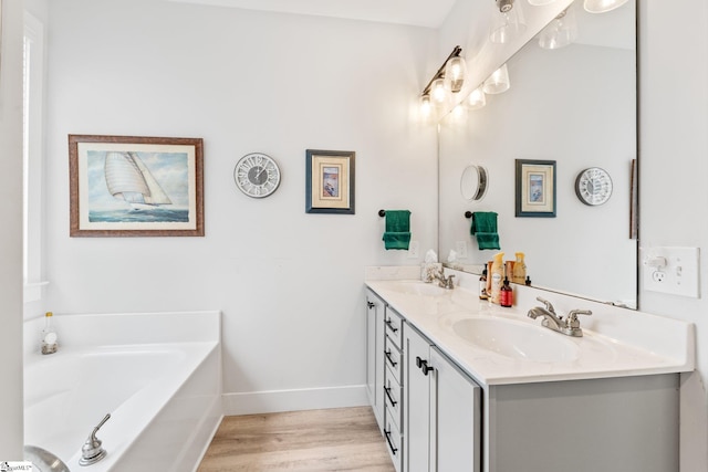 27 Mossycup Rd, Taylors, SC 29687 - bathroom with double vanity, a bath, and wood finished floors