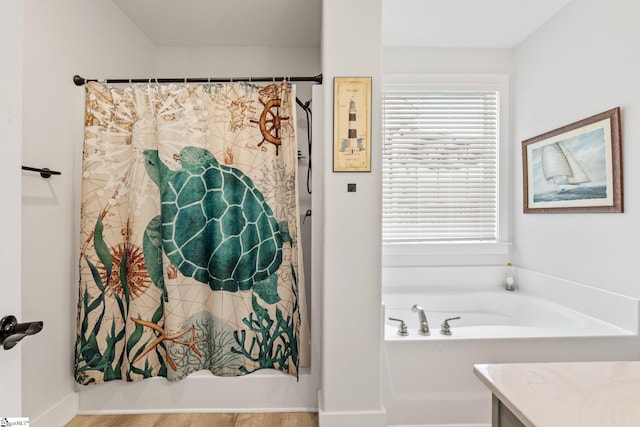 27 Mossycup Rd, Taylors, SC 29687 - bathroom with a tub to relax in, curtained shower, vanity, and wood finished floors