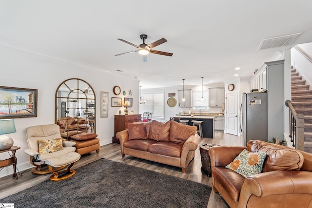 27 Mossycup Rd, Taylors, SC 29687 - living room featuring stairs, light wood-type flooring, a ceiling fan, crown molding, and recessed lighting