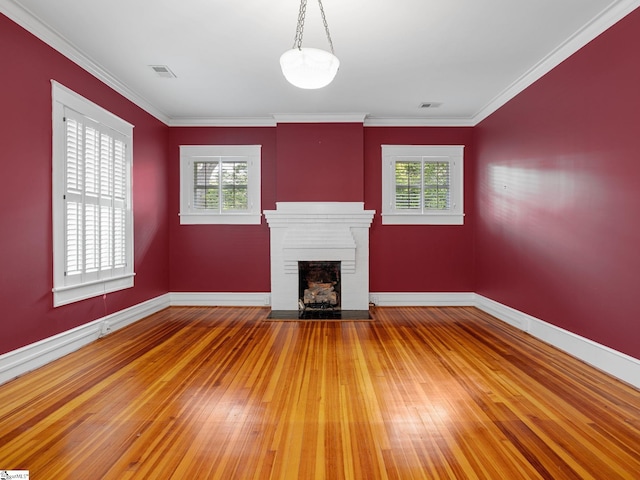 772 Glendalyn Ave, Spartanburg, SC 29302 - unfurnished living room featuring light wood-style flooring, plenty of natural light, a fireplace with flush hearth, and crown molding