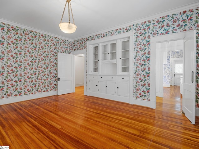 772 Glendalyn Ave, Spartanburg, SC 29302 - unfurnished bedroom with wallpapered walls, light wood finished floors, and ornamental molding