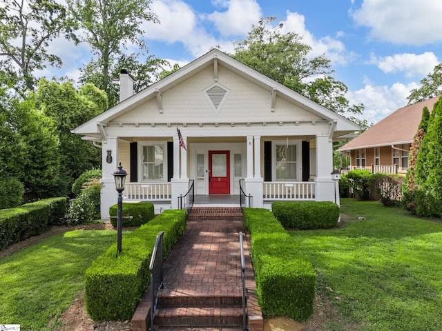 772 Glendalyn Ave, Spartanburg, SC 29302 - bungalow with a porch, a chimney, and a front yard