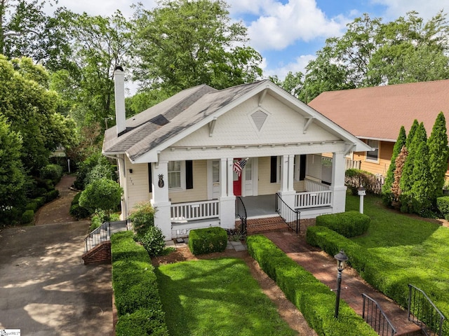 772 Glendalyn Ave, Spartanburg, SC 29302 - bungalow-style house with covered porch, a chimney, roof with shingles, and a front lawn