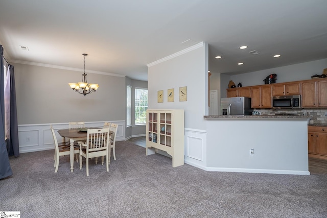 112 Pendock Ln, Piedmont, SC 29673 - dining room with a chandelier, ornamental molding, carpet, wainscoting, and a decorative wall