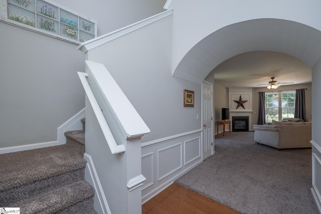 112 Pendock Ln, Piedmont, SC 29673 - stairway with ceiling fan, arched walkways, a glass covered fireplace, wood finished floors, and carpet flooring