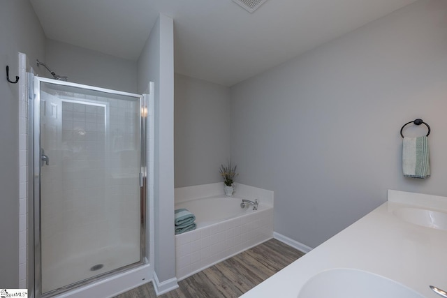 112 Pendock Ln, Piedmont, SC 29673 - bathroom with wood finished floors, a shower stall, a garden tub, and double vanity