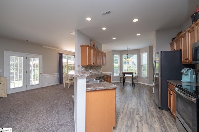 112 Pendock Ln, Piedmont, SC 29673 - kitchen with stainless steel range with electric stovetop, healthy amount of natural light, recessed lighting, a chandelier, and a wainscoted wall