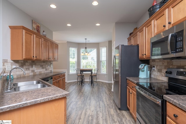 112 Pendock Ln, Piedmont, SC 29673 - kitchen with appliances with stainless steel finishes, recessed lighting, light wood-type flooring, backsplash, and a chandelier