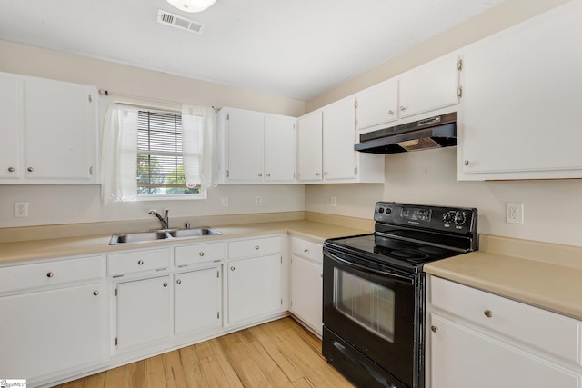 21 Lantern Ln, Greer, SC 29651 - kitchen with under cabinet range hood, black range with electric cooktop, white cabinets, light wood-type flooring, and light countertops