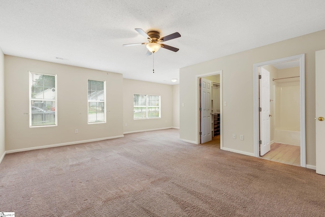 21 Lantern Ln, Greer, SC 29651 - unfurnished bedroom featuring carpet, a walk in closet, ensuite bathroom, and a ceiling fan