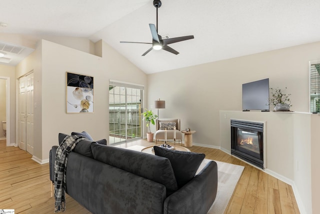 21 Lantern Ln, Greer, SC 29651 - living room featuring a glass covered fireplace, light wood-style floors, a ceiling fan, and vaulted ceiling