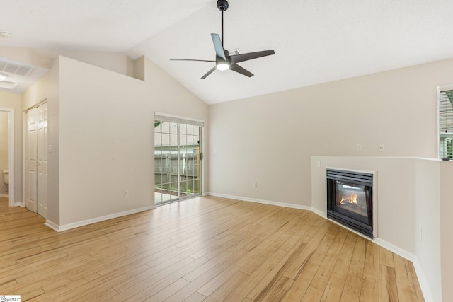 21 Lantern Ln, Greer, SC 29651 - unfurnished living room featuring a ceiling fan, a glass covered fireplace, light wood-style flooring, and high vaulted ceiling