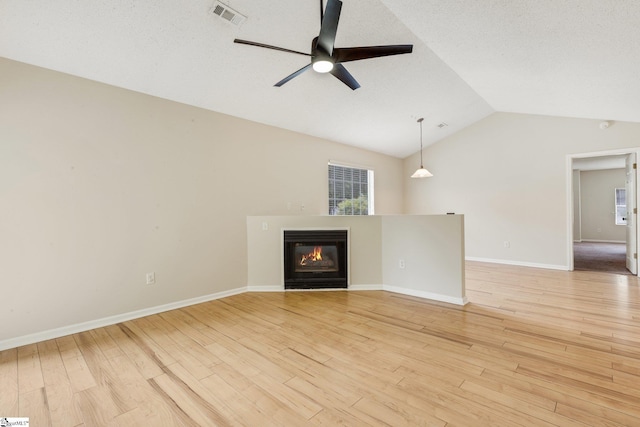 21 Lantern Ln, Greer, SC 29651 - unfurnished living room with lofted ceiling, ceiling fan, a glass covered fireplace, and light wood-style flooring