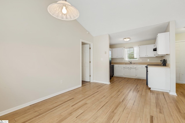 21 Lantern Ln, Greer, SC 29651 - kitchen featuring light wood-type flooring, white cabinets, stove, vaulted ceiling, and light countertops