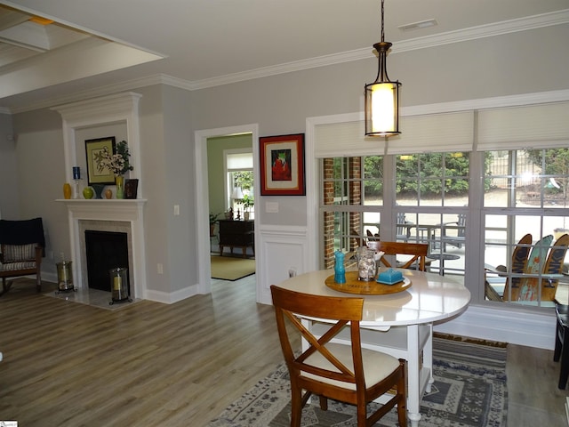 811 White Magnolia Dr, Inman, SC 29349 - dining area with wood finished floors, ornamental molding, and a fireplace with flush hearth
