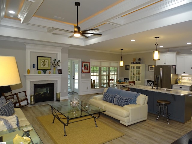 811 White Magnolia Dr, Inman, SC 29349 - living area with light wood-style floors, ornamental molding, a ceiling fan, beam ceiling, and a fireplace with flush hearth