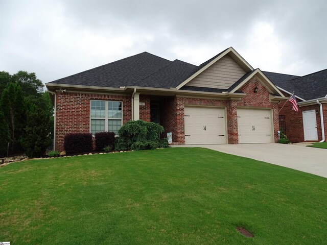 811 White Magnolia Dr, Inman, SC 29349 - view of front of house with an attached garage, a front yard, brick siding, driveway, and a shingled roof