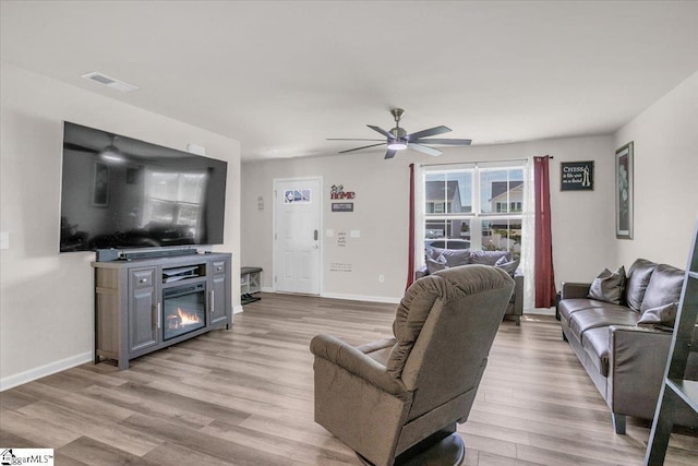 243 Lily Park Way, Easley, SC 29642 - living area featuring light wood-style floors, ceiling fan, and a glass covered fireplace