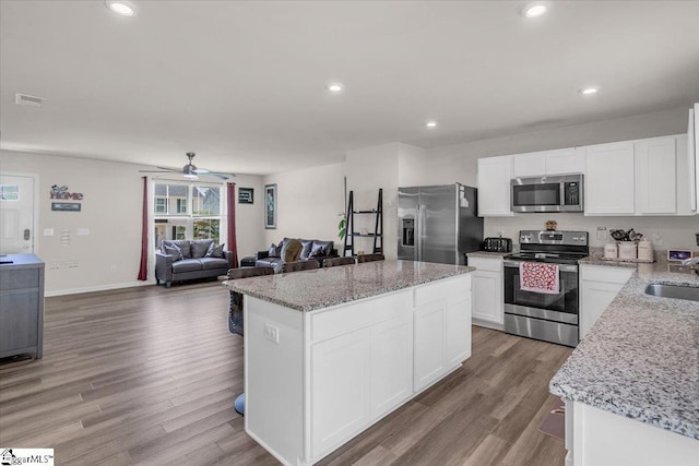 243 Lily Park Way, Easley, SC 29642 - kitchen with appliances with stainless steel finishes, a center island, light wood-style flooring, ceiling fan, and recessed lighting