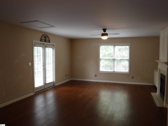 279 Finch Rd, Wellford, SC 29385 - unfurnished living room featuring dark wood-style floors, a fireplace with flush hearth, and a ceiling fan