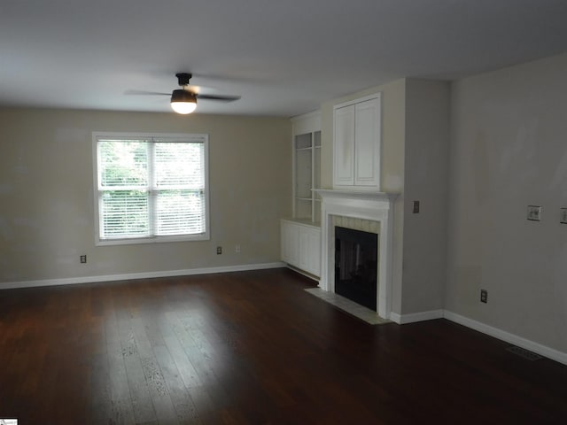 279 Finch Rd, Wellford, SC 29385 - unfurnished living room with a ceiling fan, a tile fireplace, and dark wood-style floors