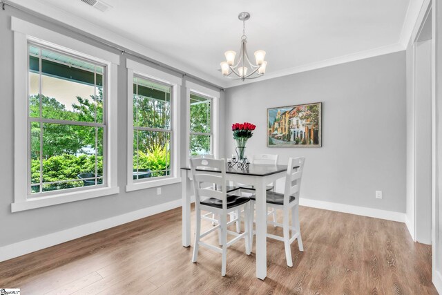 542 Drayton Hall Blvd, Duncan, SC 29334 - dining space with a chandelier, light wood-style flooring, and crown molding