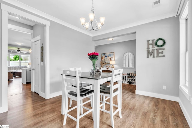 542 Drayton Hall Blvd, Duncan, SC 29334 - dining space featuring a chandelier, wood finished floors, and crown molding