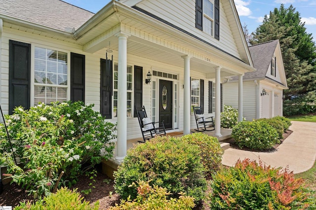 104 Superior Way, Greer, SC 29651 - property entrance featuring a porch, a shingled roof, and an attached garage