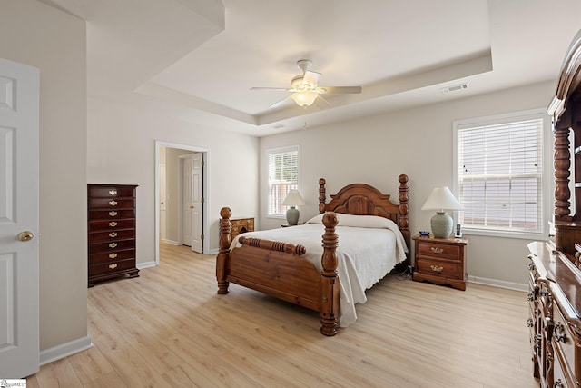 6 Castle Hall Ct, Simpsonville, SC 29681 - bedroom featuring a tray ceiling, light wood-style flooring, and ceiling fan