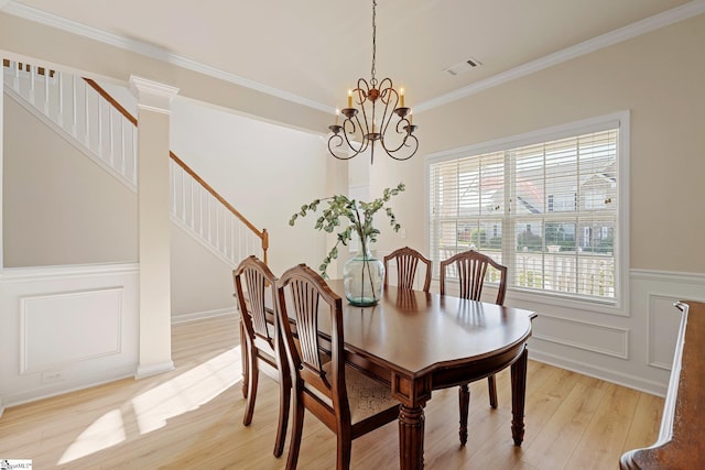 6 Castle Hall Ct, Simpsonville, SC 29681 - dining area with a chandelier, light wood-style flooring, stairs, crown molding, and a wainscoted wall