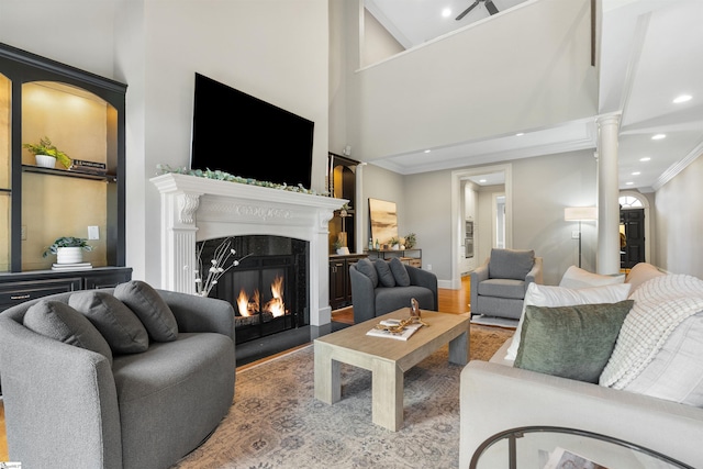 623 N Main St Unit Iii, Unit Iii, Greenville, SC 29601 - living room featuring ornate columns, a fireplace with flush hearth, recessed lighting, ornamental molding, and a high ceiling